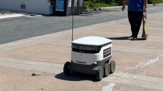 Automated food delivery robot rolls down street, University of California Irvine, April 2023