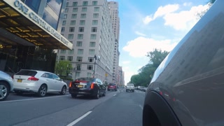 Driving POV in New York City through Columbus Circle and Past Trump Tower.
