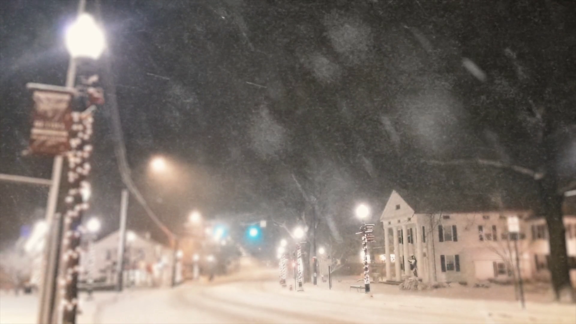Snowstorm covers roads & Christmas decorations at night in Bethel Connecticut Stock Video