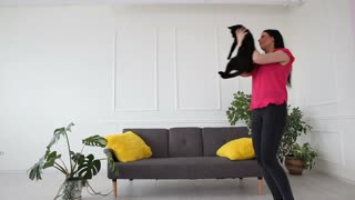 Love for Pets: Girl Dancing with a Cat at Home