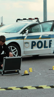 A Police Officer is Thoroughly Examining Evidence at the Crime Scene to Gather Details