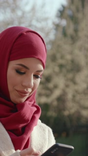 A Stunning Profile of a Woman Wearing a Red Hijab Against a Beautiful Bright Sky