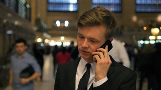 City Lifestyle Portrait of Man Talking on Phone While standing in crowded urban area, time lapse
