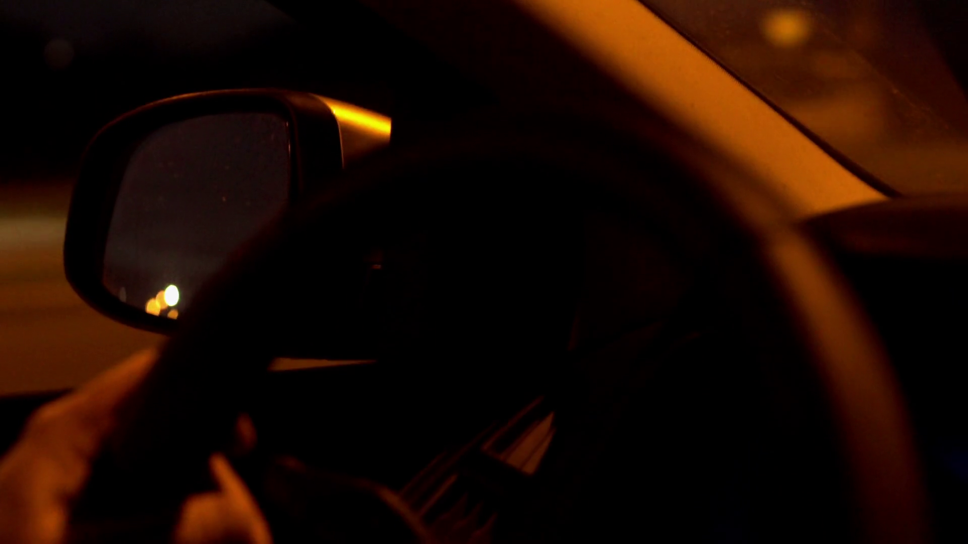 Person driving a car at night and having a trip, steadycam shot Stock