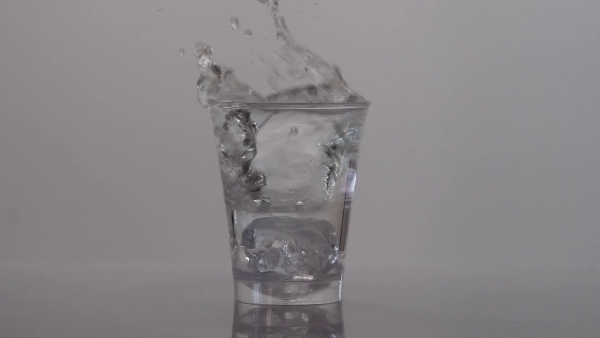 ice-cubes-falling-into-glass-of-water-slow-motion-stock-video-footage