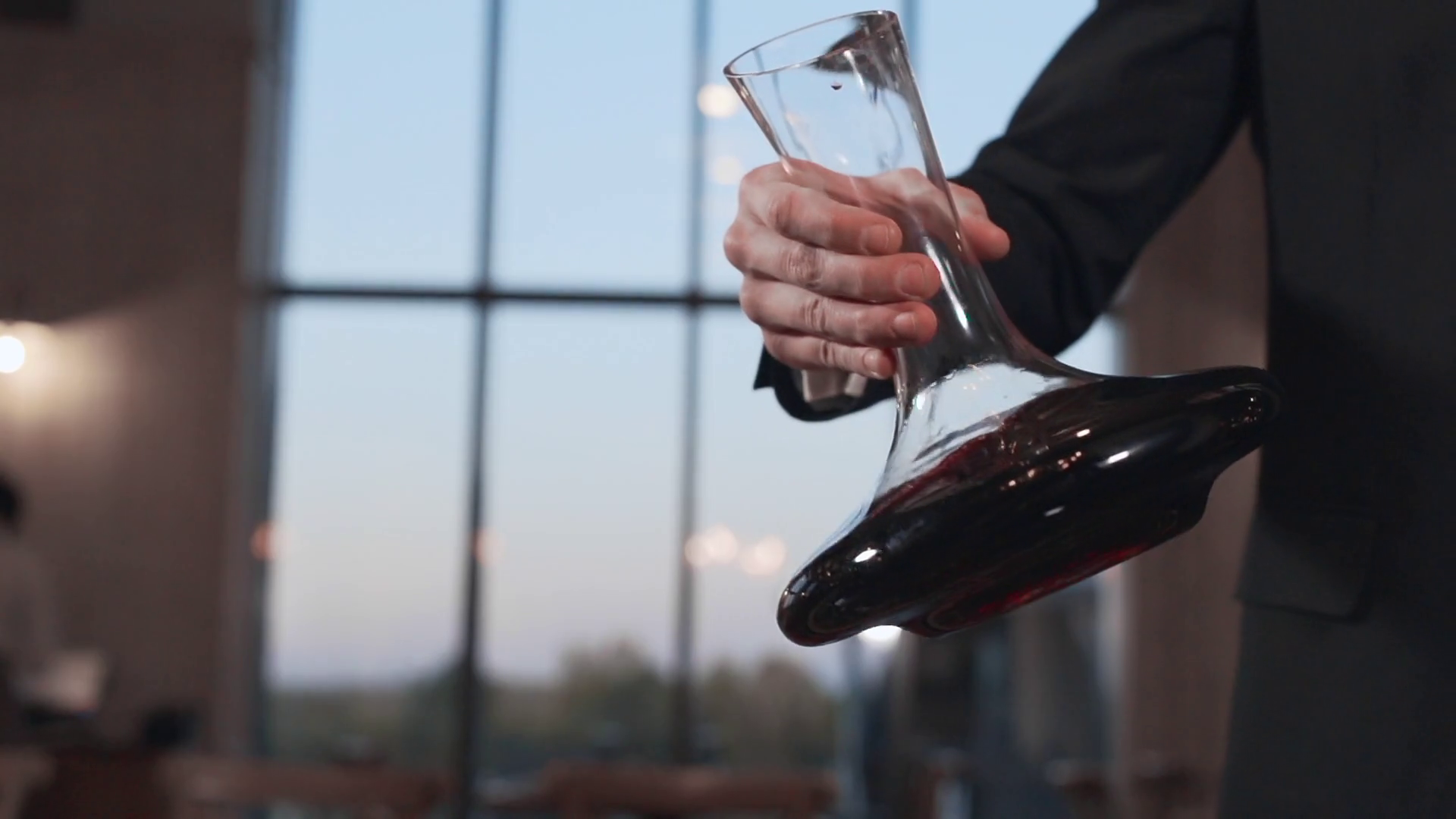 Barman shakes the wine in a decanter in slow motion, 240 frames per