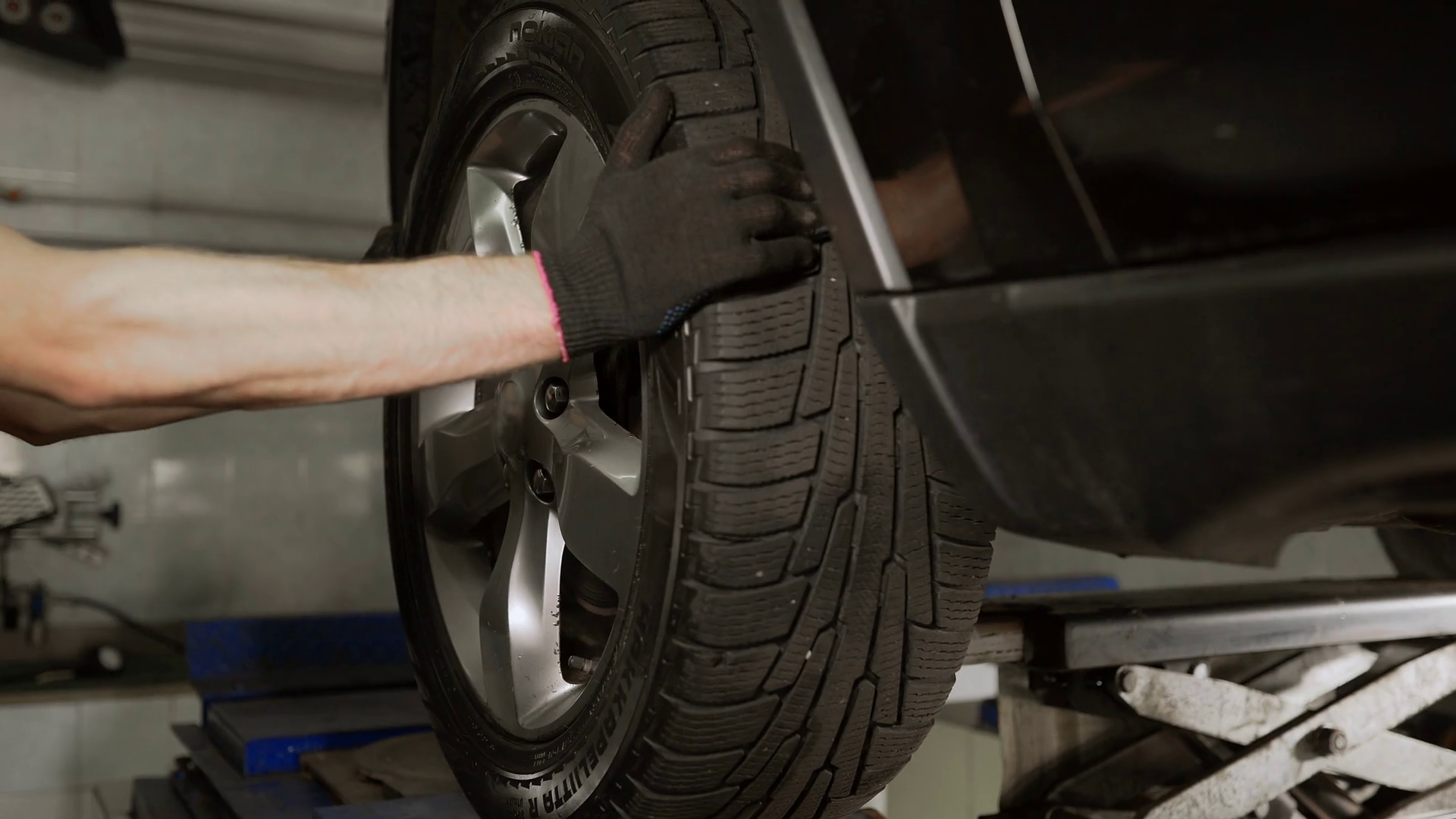 Mechanic checks suspension at the car service station, suspension