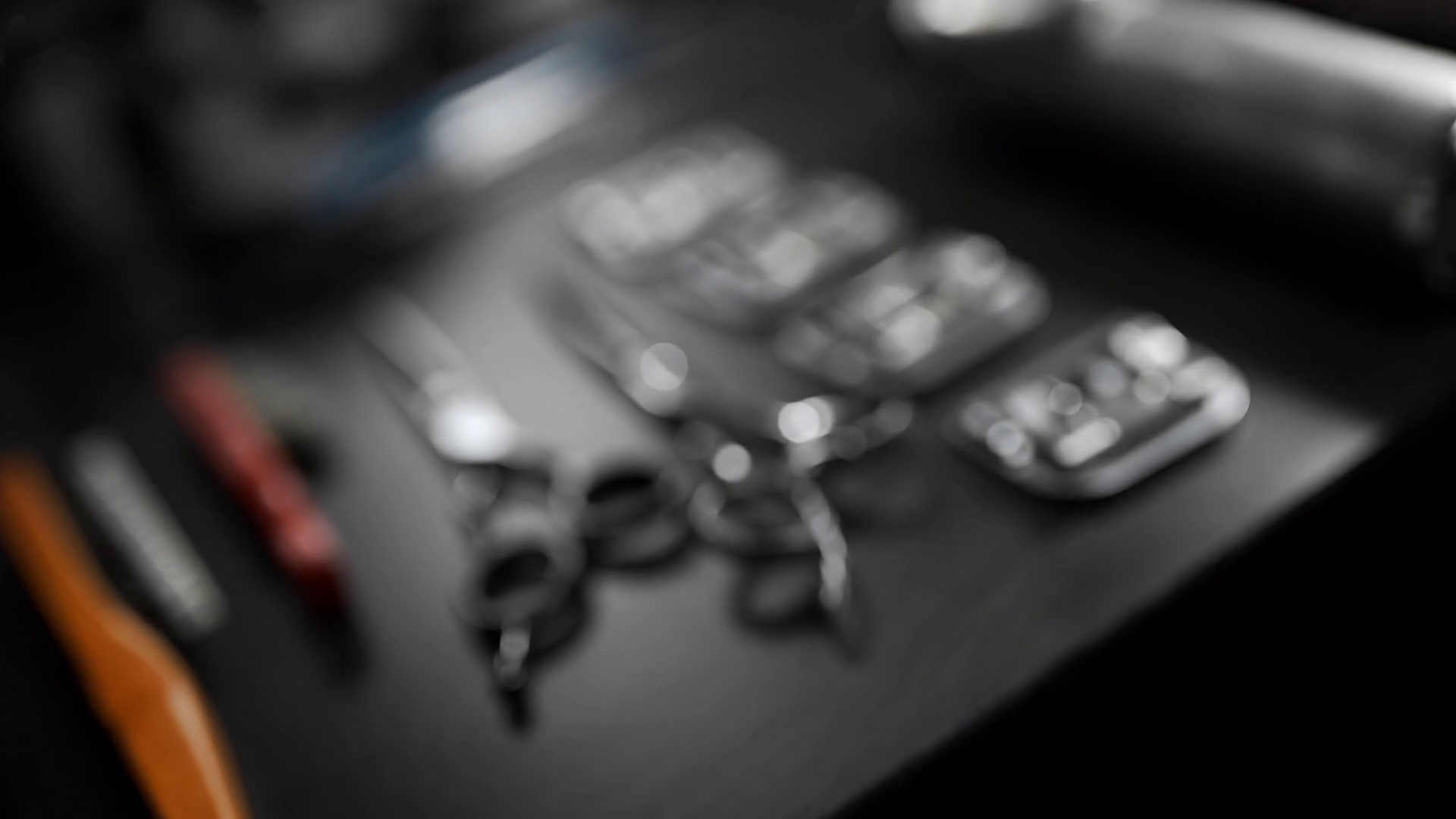 Table with scissors and trimmers at the barber shop, making of haircuts, straight razor on the