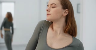 Yoga instructor demonstrates shoulder warm-up exercises at the White Hall, trainer leads yoga and pilates training, 4k 120p Prores HQ