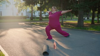 Plus size woman practicing yoga in park