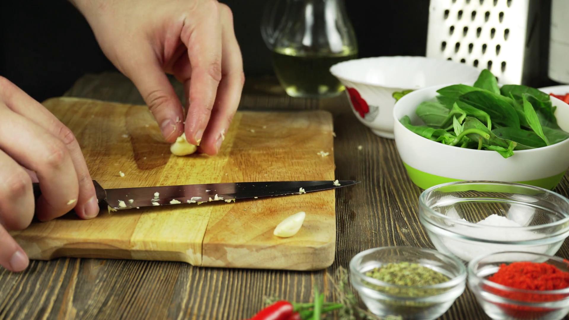 The chef slices the garlic. Knife, chopping Board, garlic. Quick