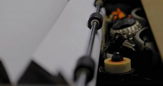 ECU OF THE BALL AND CARRIAGE ON A VINTAGE ELECTRIC TYPEWRITER, IN USE.  C4K, 10 BIT