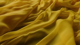 Abstract tenderness yellow peach silk background luxury wave cloth satin pastel color fabric, textures of dress with milk liquid wave splash