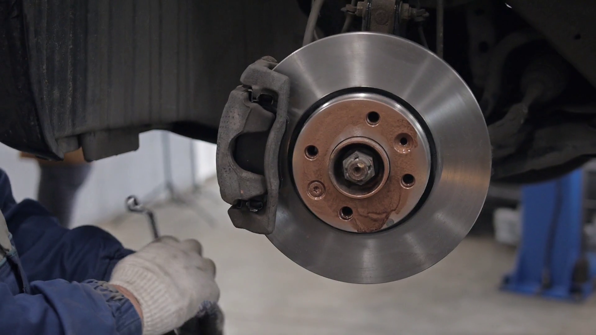 Car Mechanic Repairing Brakes On Car In Stock Footage SBV309631612