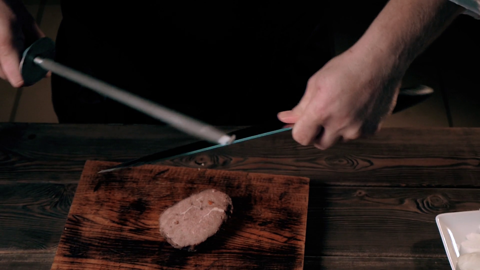 Midsection Of Male Chef Sharpening Knife In Stock Footage SBV309799673