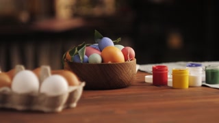 Happy Easter holiday. Coloring eggs close-up. Woman preparing for Easter, painting and decorating eggs. Christian celebration, family traditions.