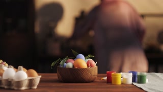 Happy Easter holiday. Coloring eggs close-up. Woman preparing for Easter, painting and decorating eggs. Christian celebration, family traditions.