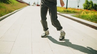 Dancer woman dancing outdoor, legs close-up. Modern dance choreography. Female professional street dancer showing dance movings. Musical video clip.