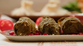 Arabian cuisine. Turkish traditional food. Dolma close-up, meat in leaves, middle eastern national food. Muslim family dinner, Ramadan