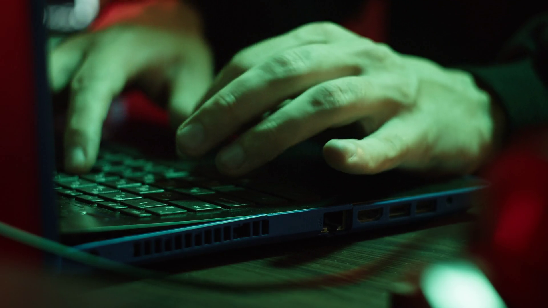 Professional hacker typing on keyboard at night, close-up of man hands ...