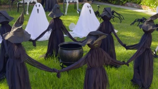 Halloween witches circle with cauldron and ghosts on lawn