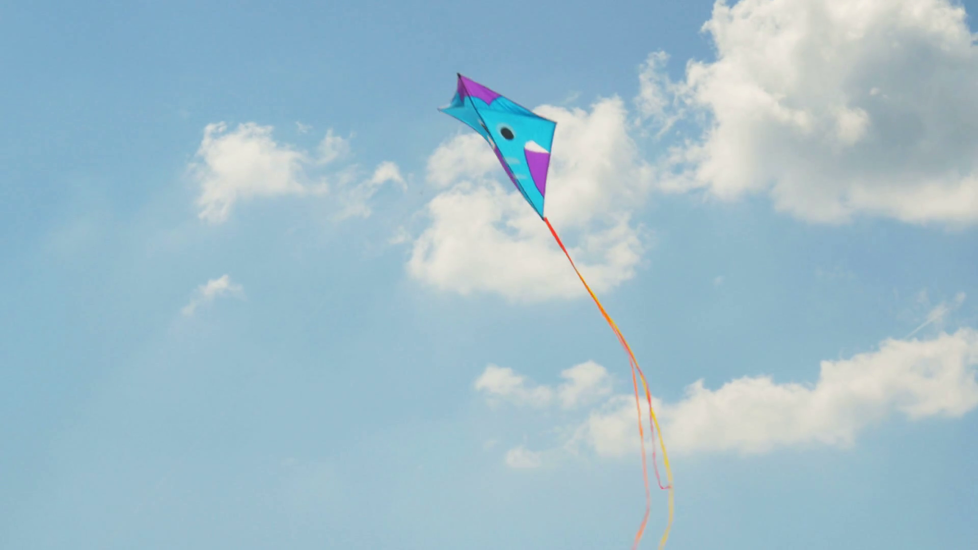 Colorful Kite Flying In Blue Sky With Clouds Stock Footage SBV