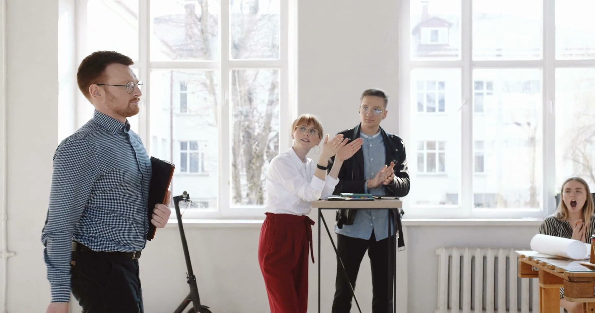 Side vies happy young successful male boss walking along loft office