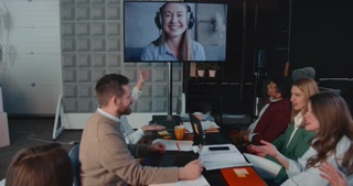 Happy female CEO, executive manager leads team business meeting via web conference, video call at office slow motion.