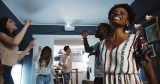 Happy multiethnic millennial friends have amazing fun dancing together at vacation party enjoying life slow motion.
