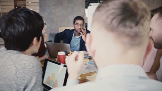 Diverse business team discusses corporate strategy in 4K.