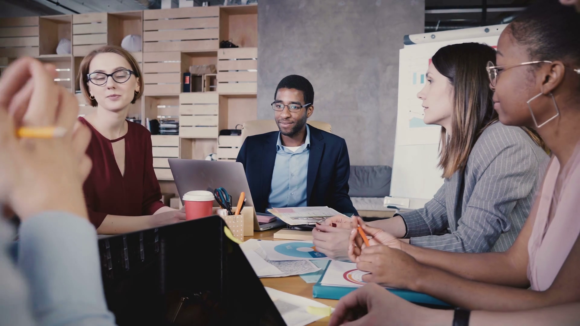 Business collaboration in modern loft office. Young happy multiethnic