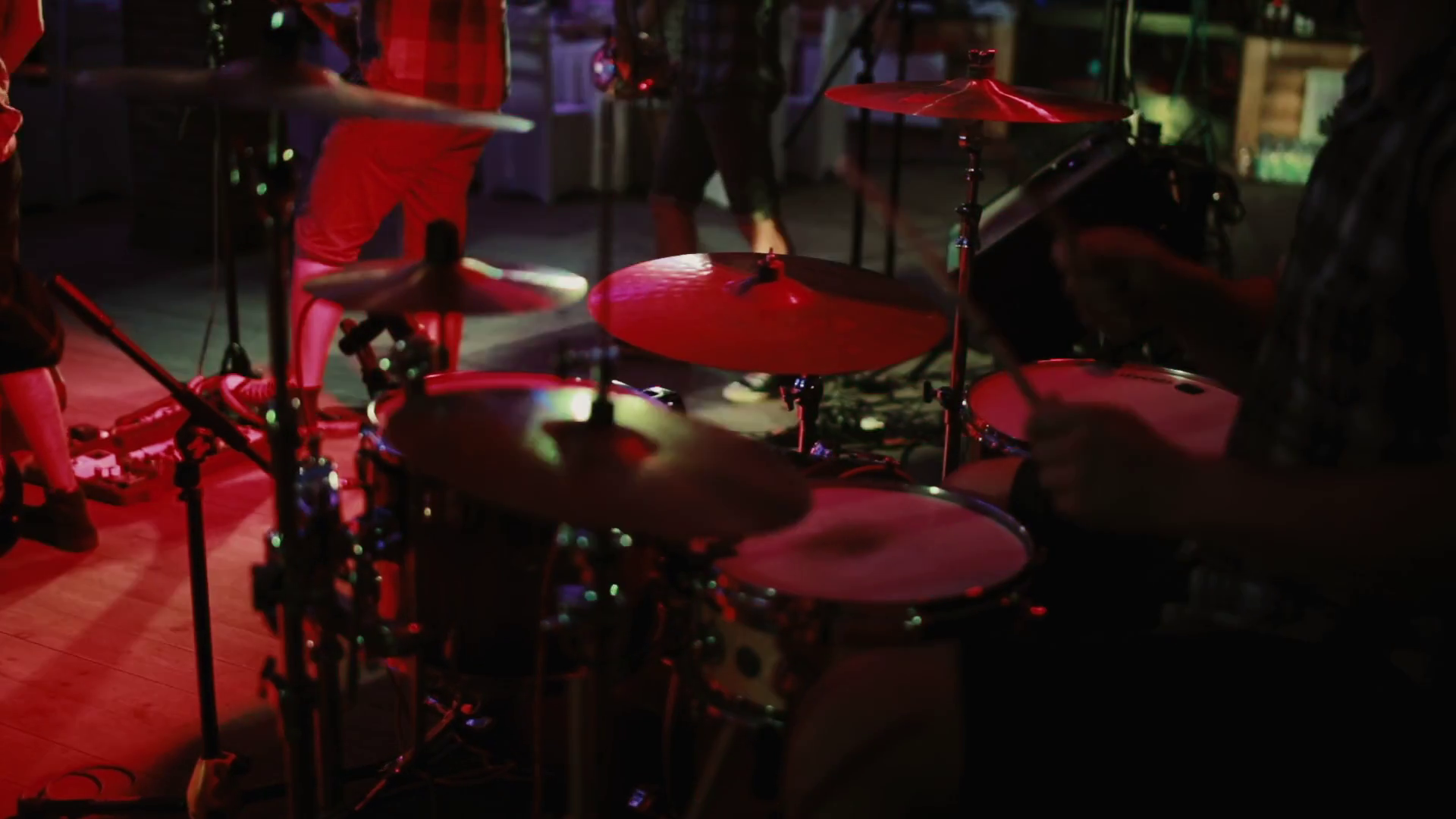 Closeup view of drummer plays on stage. Concert rock band in a or prom. Man uses a