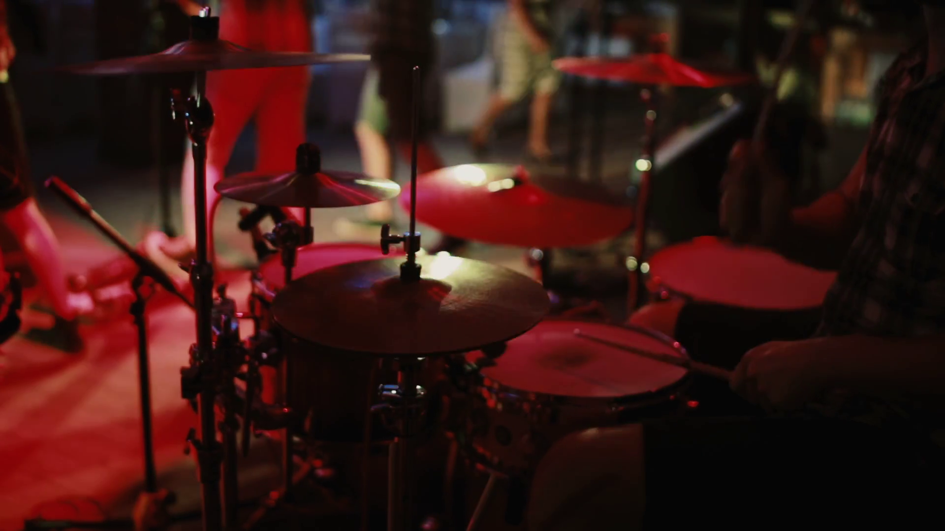 Closeup view of drummer plays on stage. Concert rock band in a