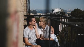 Romantic couple enjoying sunny balcony together