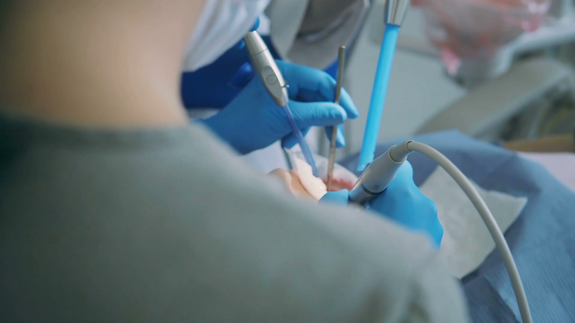 Young woman visiting the dentist. Doctor with dental nurse treating a