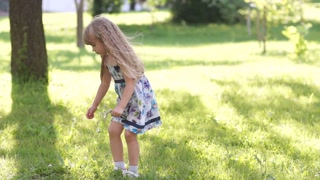 3s Happy girl picking flowers in the meadow