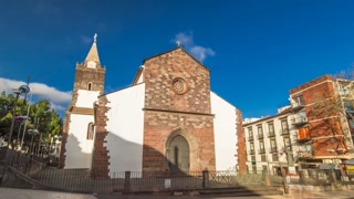 Catholic church in Funchal, Madeira island, Portugal timelapse hyperlapse with blue cloudy sky at sunny day 4K