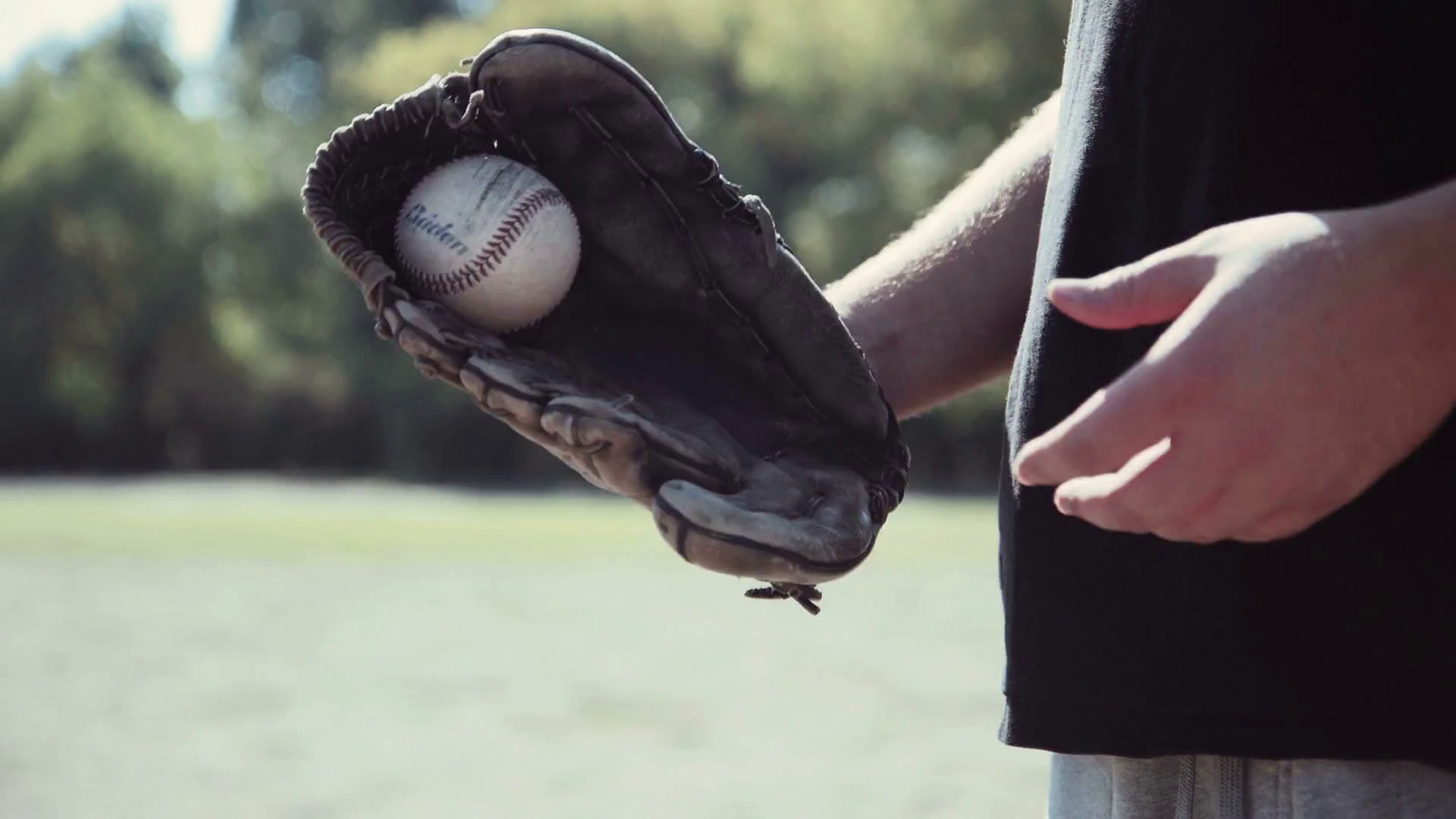 Close Up of Man Wearing Baseball Glove and Tossing Baseball from Hand