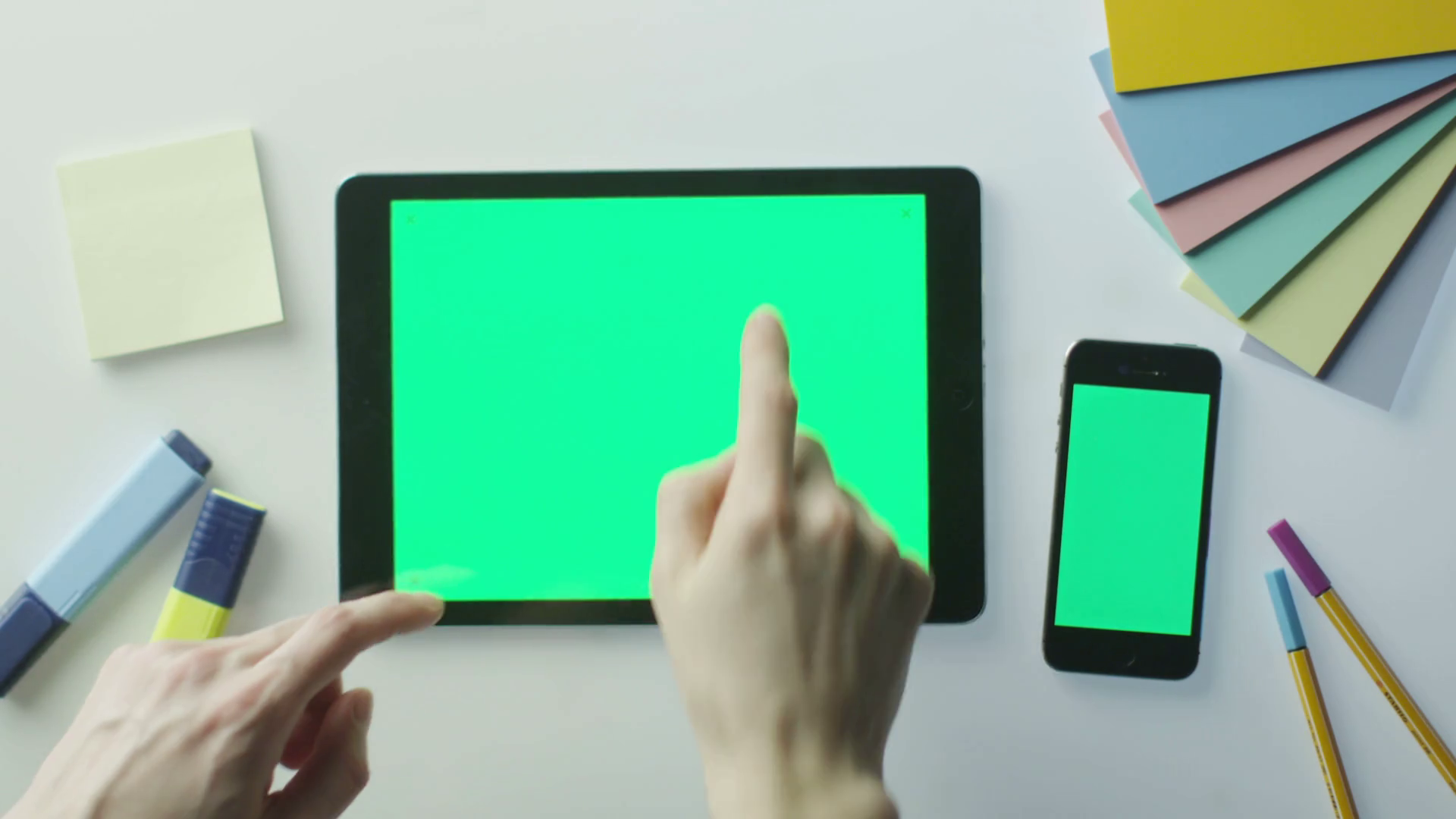 Designer is Using Tablet and Mobile Phone with Green