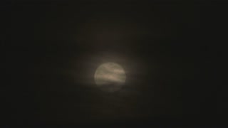 Full Moon at Night Behind Clouds