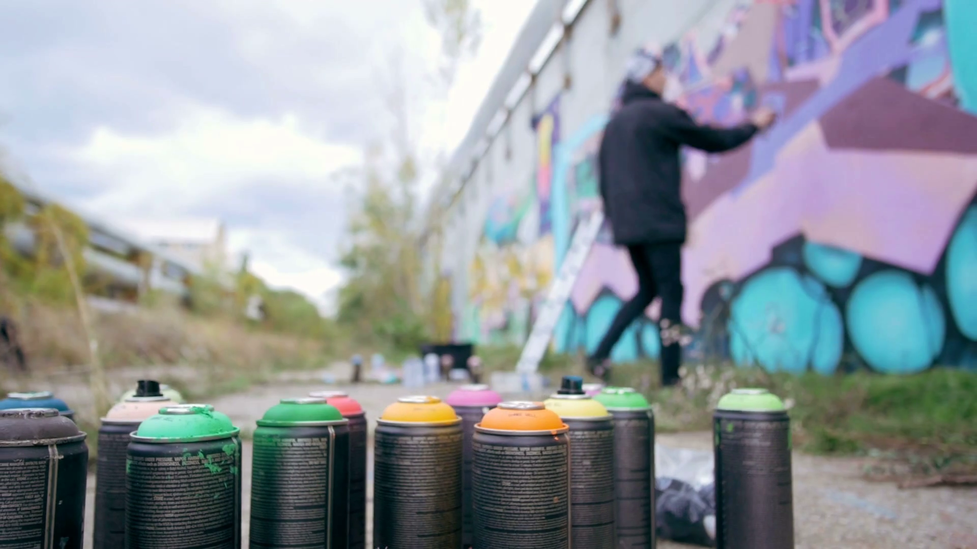 Graffiti artists painting on the wall, exterior Stock Video Footage