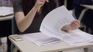 High school student in class studying and doing homework