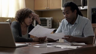 African American family looking at bills due