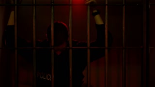 Police Officer Sad Behind Bars In Jail