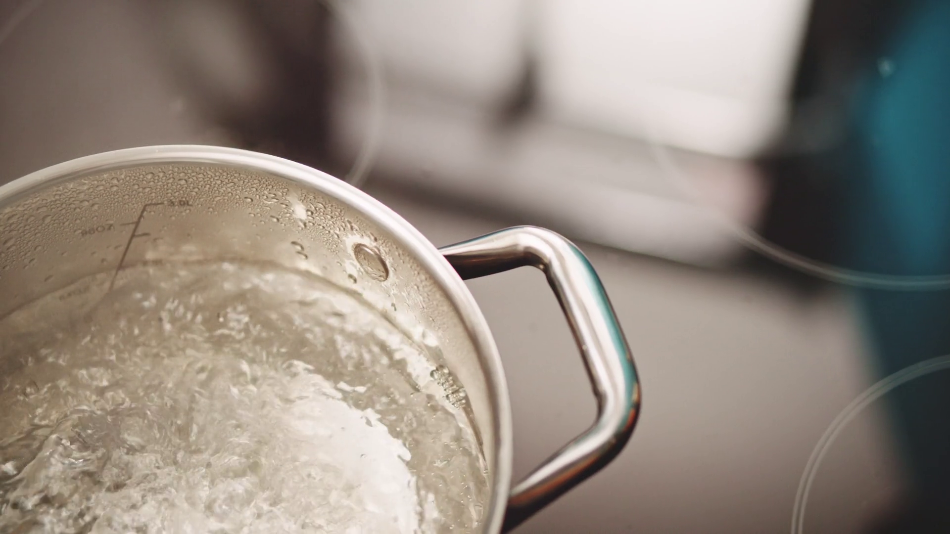 Slow motion pan over boiling water in kitchen Stock Video Footage 0018