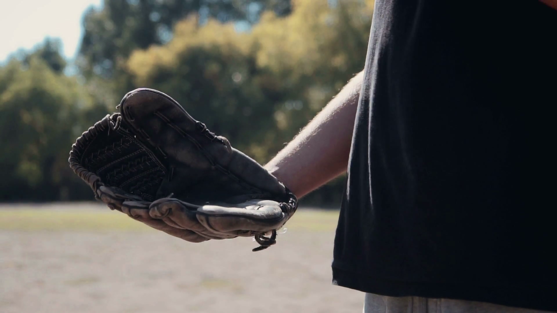 Slowmotion Close Up of Man Wearing Baseball Glove and Tossing Baseball
