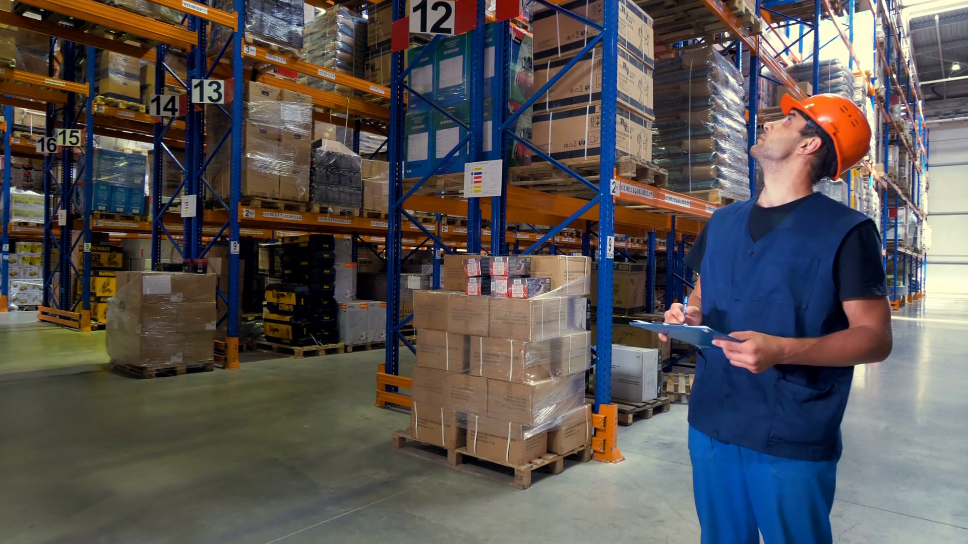 A Warehouse Employee Looks Around Different Aisles Stock Video Footage 