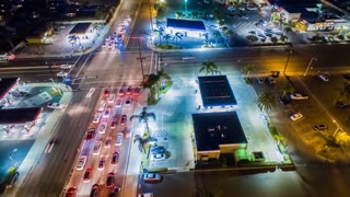 Aerial cinematic timelapse in motion or hyperlapse looking at an urban intersection showing the busy city traffic at rush hour from above.