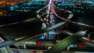 Cinematic urban aerial time lapse from above of interstate traffic at night.