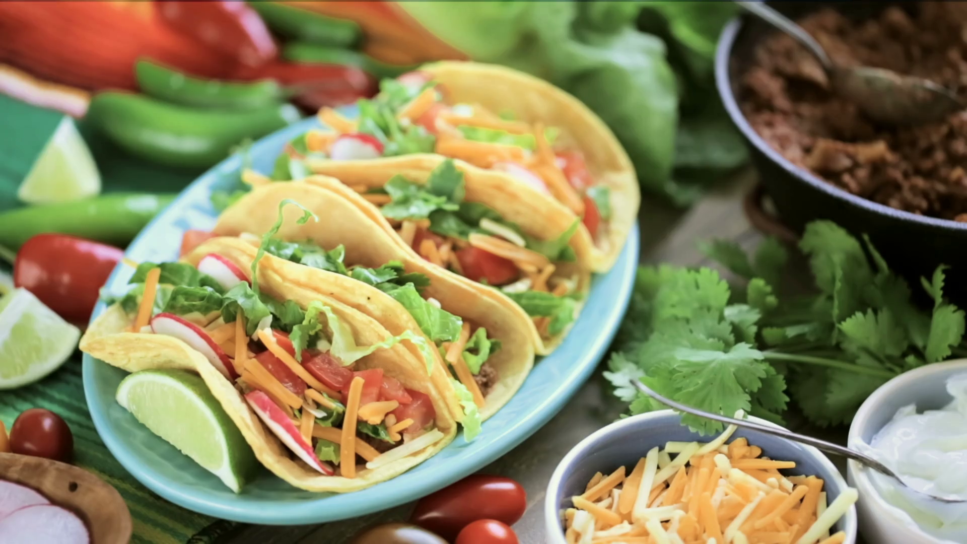 Serving ground beef tacos with romaine lettuce, diced tomatoes